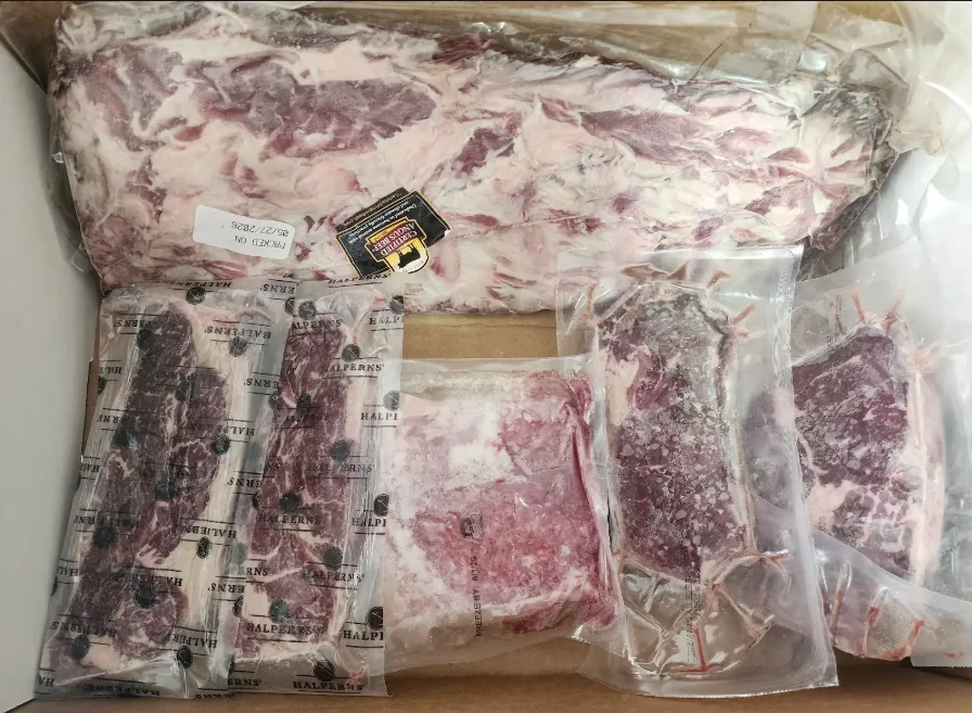 Real mixed beef case with vacuum-sealed cuts